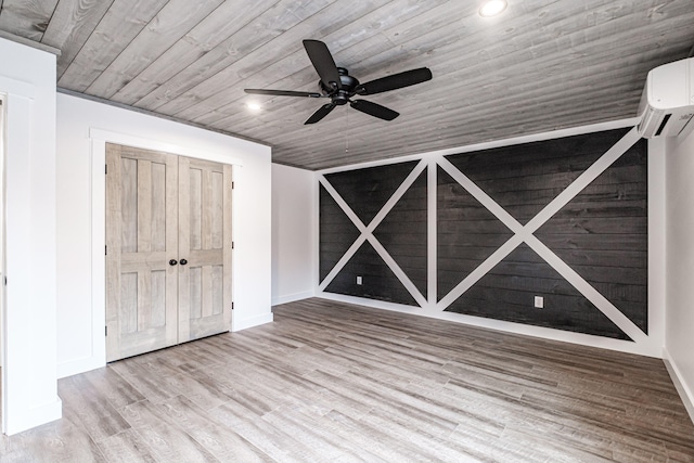 unfurnished bedroom featuring light hardwood / wood-style floors, a wall unit AC, ceiling fan, wood ceiling, and a closet