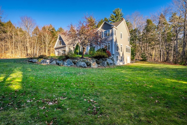 view of side of home featuring a lawn