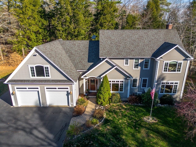 view of front facade with a garage and a front lawn