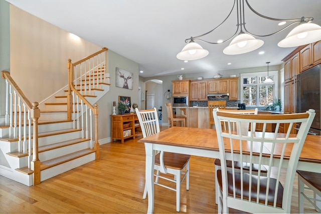 dining space featuring a chandelier and light hardwood / wood-style floors