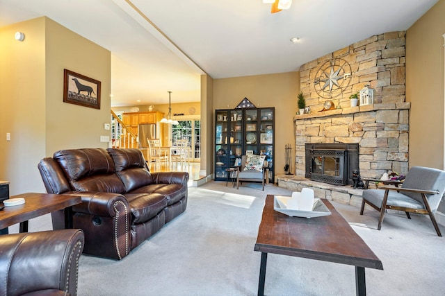 living room with a fireplace and light colored carpet