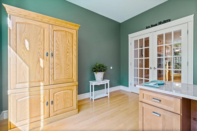 interior space featuring french doors and light hardwood / wood-style flooring