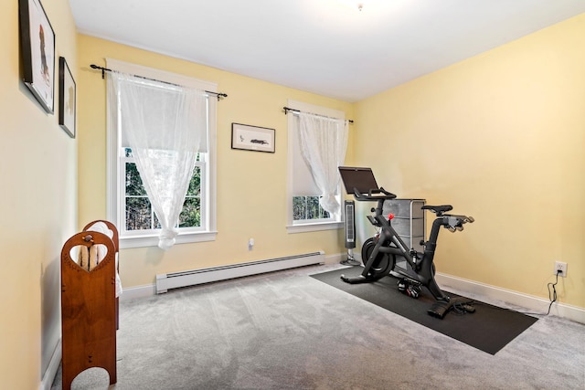 exercise room featuring a baseboard radiator and light colored carpet