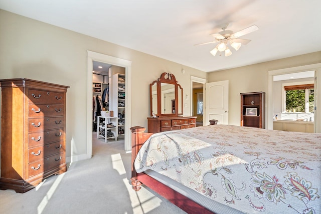 carpeted bedroom featuring a spacious closet, a closet, and ceiling fan