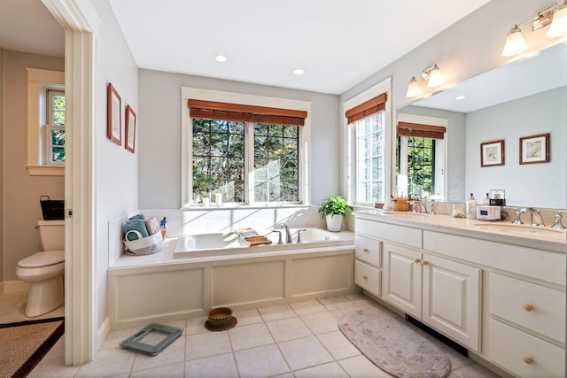 bathroom with tile patterned flooring, vanity, plenty of natural light, and a bathing tub