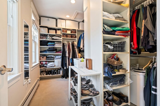 spacious closet with carpet and baseboard heating