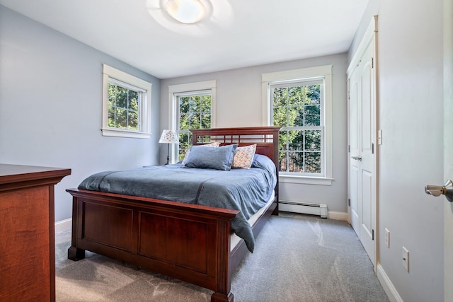 carpeted bedroom featuring a baseboard radiator