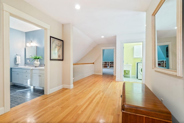 corridor featuring washer / clothes dryer and hardwood / wood-style flooring