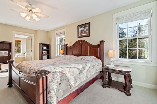 carpeted bedroom with multiple windows and ceiling fan