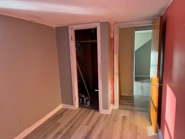 unfurnished bedroom with light hardwood / wood-style floors and a closet