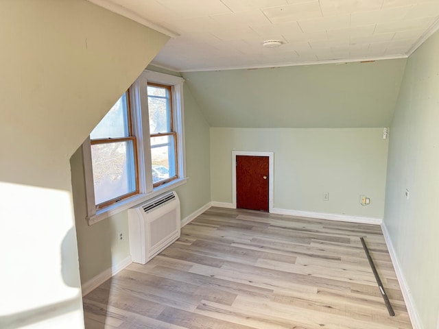 bonus room with light hardwood / wood-style floors, a wall unit AC, and lofted ceiling