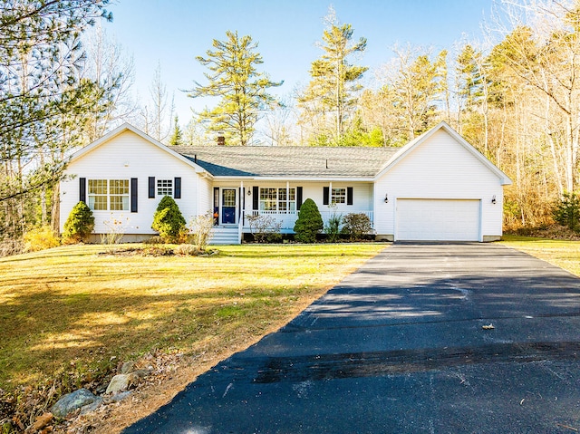 ranch-style house featuring a front yard, a porch, and a garage