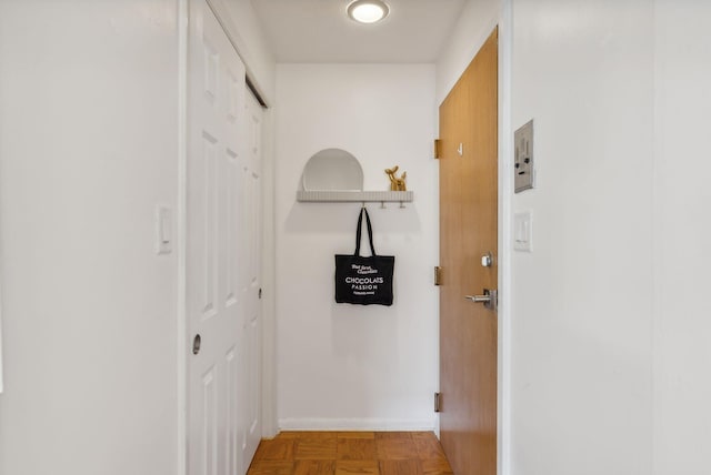 hall featuring parquet flooring