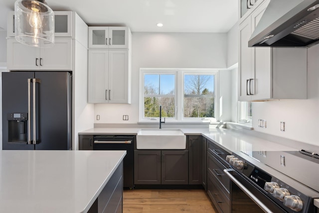 43 Rose Douglas Ln, Brunswick, ME 04011 - kitchen with fridge with ice dispenser, wall chimney range hood, black dishwasher, a sink, and stainless steel electric range