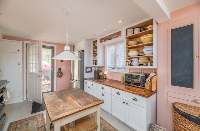 27 Mace Ave, Winthrop, ME 04364 - kitchen with wood counters, open shelves, freestanding refrigerator, white cabinets, and hanging light fixtures