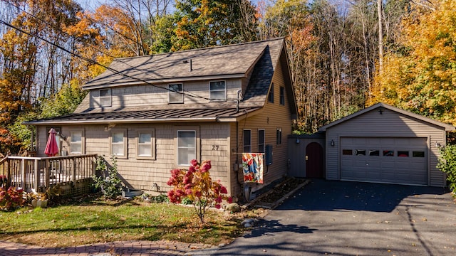 27 Mace Ave, Winthrop, ME 04364 - view of front of property with a standing seam roof, an outbuilding, metal roof, a shingled roof, and a deck