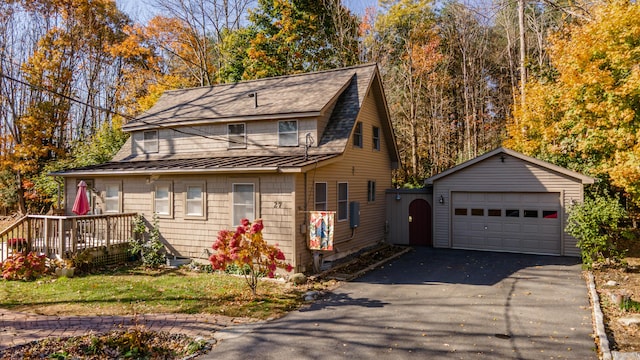 27 Mace Ave, Winthrop, ME 04364 - view of front facade featuring an outbuilding, a standing seam roof, roof with shingles, a detached garage, and metal roof