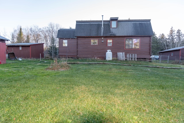 back of house with a lawn