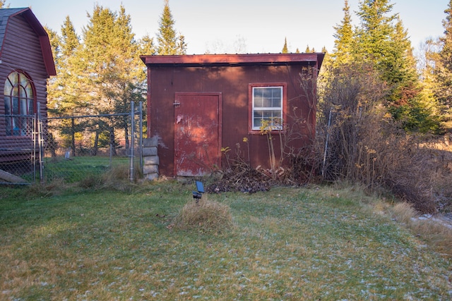 view of outbuilding with a yard