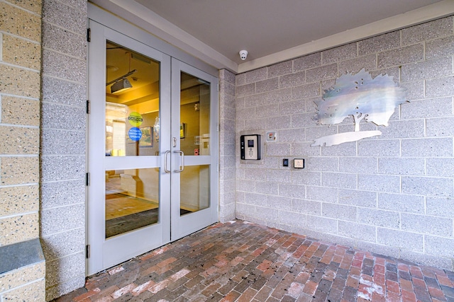 21 Chestnut St Unit 304, Portland, ME 04101 - view of exterior entry with french doors, concrete block siding, and a surveillance system
