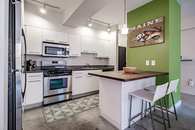 21 Chestnut St Unit 304, Portland, ME 04101 - kitchen featuring appliances with stainless steel finishes, butcher block counters, track lighting, and a sink