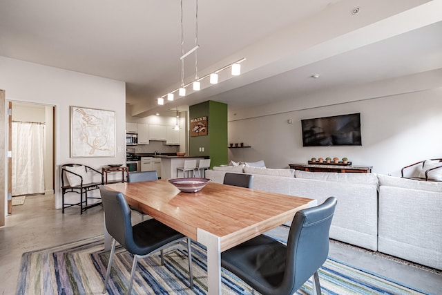 dining area featuring concrete flooring