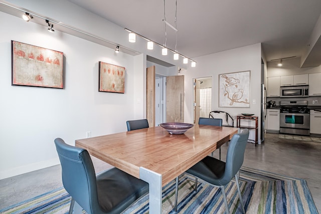 21 Chestnut St Unit 304, Portland, ME 04101 - dining room featuring rail lighting, finished concrete floors, and baseboards
