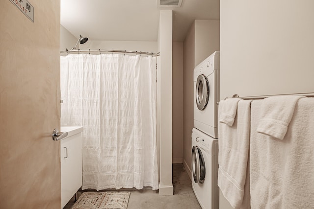 laundry area featuring stacked washing maching and dryer