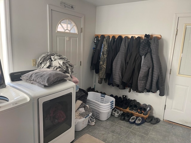 washroom with washing machine and clothes dryer and tile patterned flooring