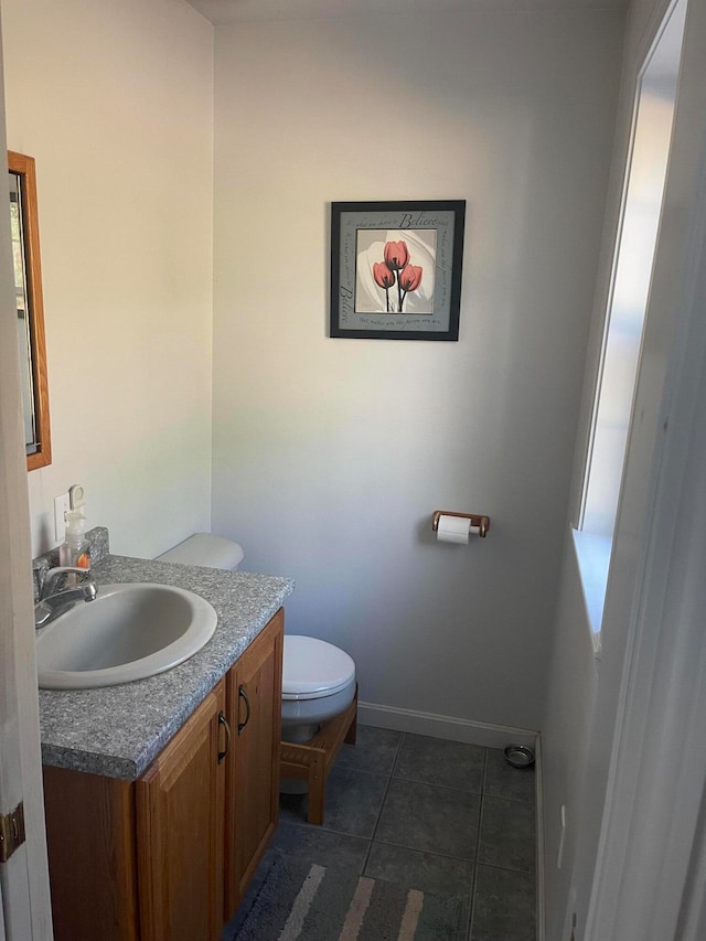 bathroom featuring tile patterned floors, vanity, and toilet