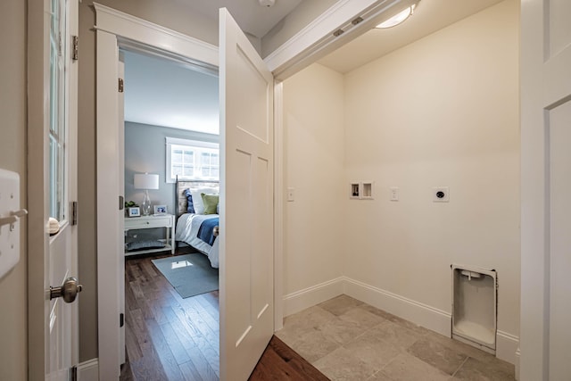 washroom with light hardwood / wood-style flooring, washer hookup, and hookup for an electric dryer