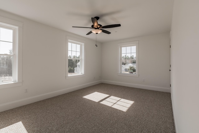 empty room with ceiling fan and dark carpet