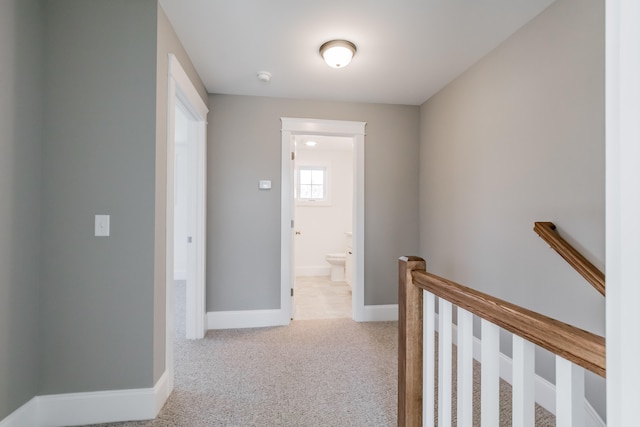 hallway featuring light carpet