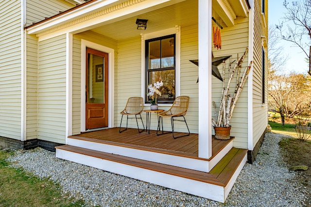 view of exterior entry featuring covered porch