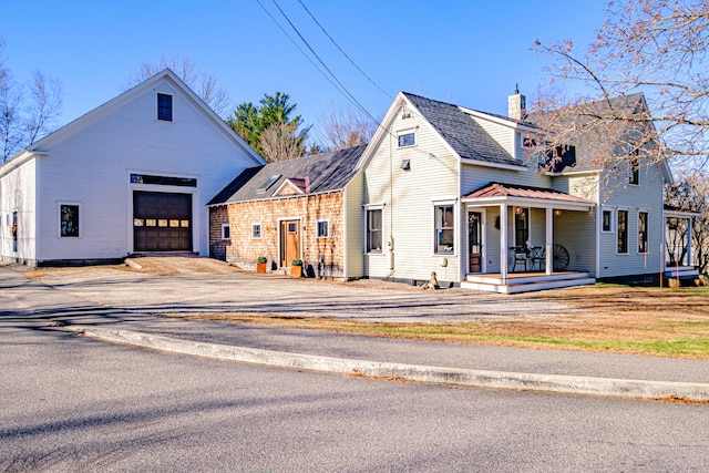 view of front facade featuring a porch and a garage