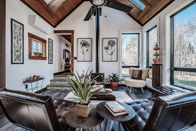 living room featuring ceiling fan, a skylight, high vaulted ceiling, and a wall mounted AC