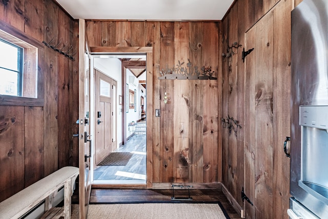 interior space with light hardwood / wood-style floors and wooden walls