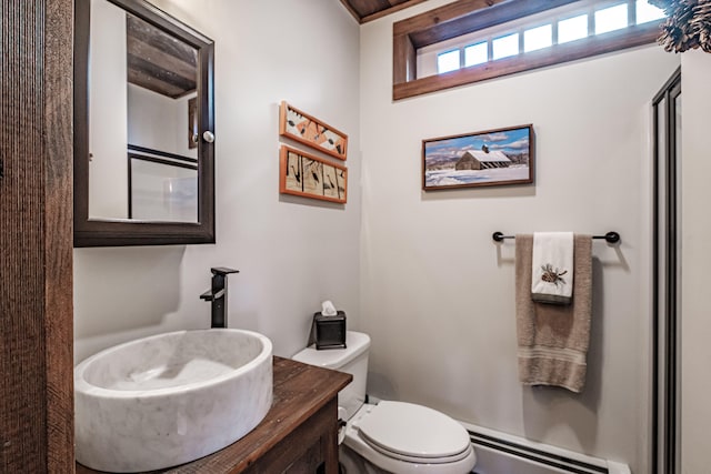 bathroom featuring vanity, toilet, and a baseboard heating unit