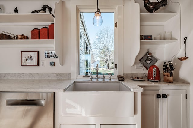 kitchen featuring stainless steel dishwasher, decorative light fixtures, light stone counters, and white cabinets