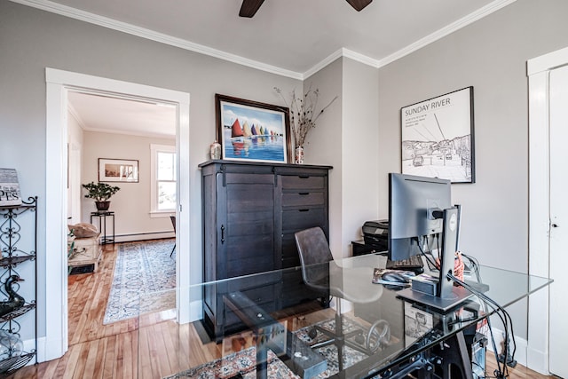 home office with ceiling fan, ornamental molding, a baseboard heating unit, and hardwood / wood-style flooring