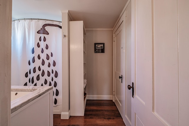 clothes washing area with dark hardwood / wood-style flooring