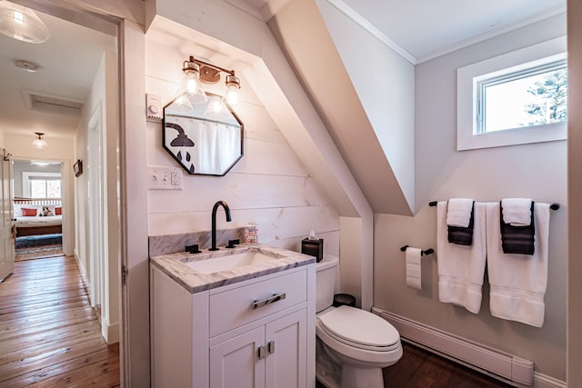 bathroom with hardwood / wood-style flooring, plenty of natural light, ornamental molding, and vanity