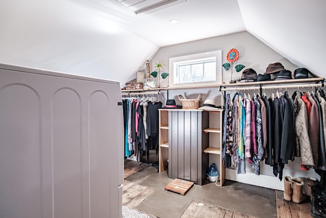 walk in closet featuring light hardwood / wood-style flooring and vaulted ceiling