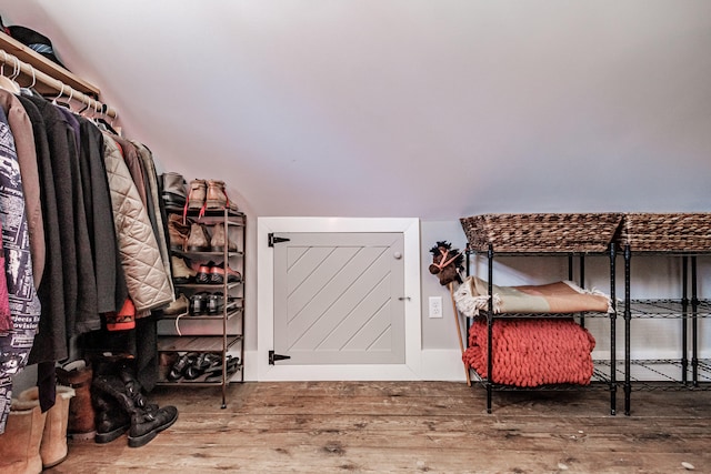 spacious closet featuring wood-type flooring and vaulted ceiling