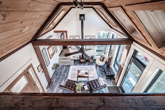 living room featuring a wealth of natural light, ceiling fan, and vaulted ceiling