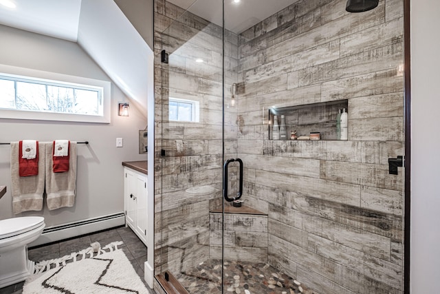 bathroom with tile patterned floors, an enclosed shower, vanity, a baseboard heating unit, and toilet