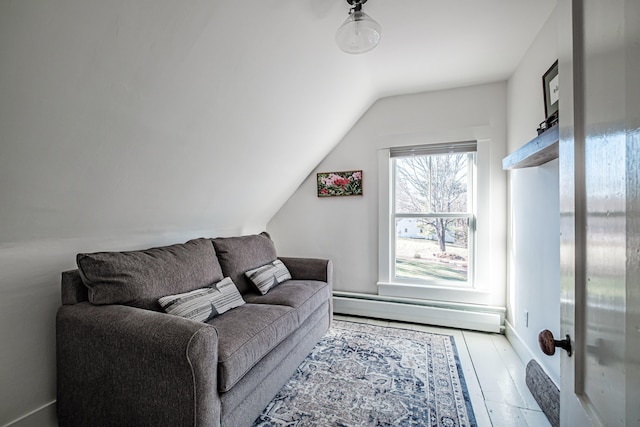 living room featuring baseboard heating, lofted ceiling, and hardwood / wood-style flooring