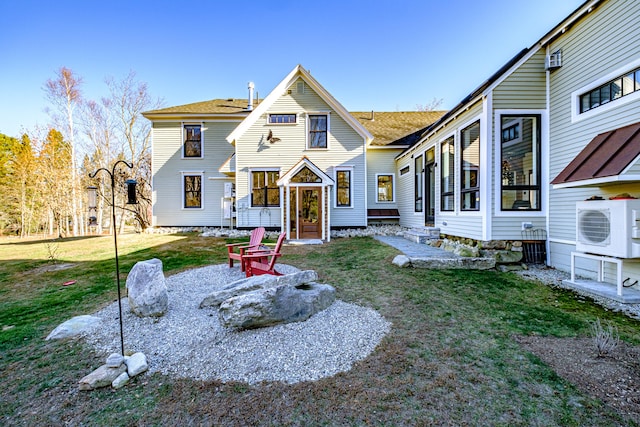 view of front facade with ac unit and a front yard