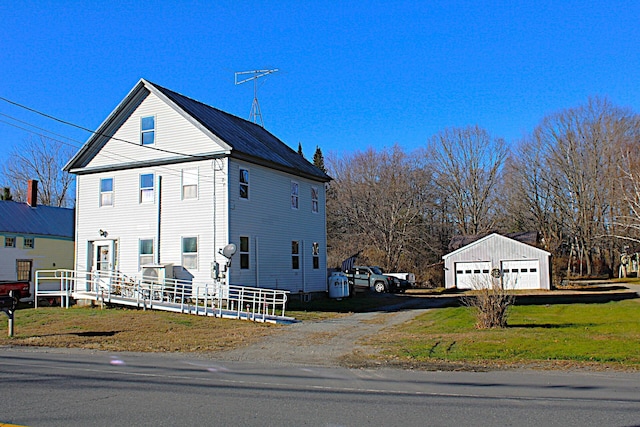 view of property exterior featuring a yard, a garage, and an outdoor structure