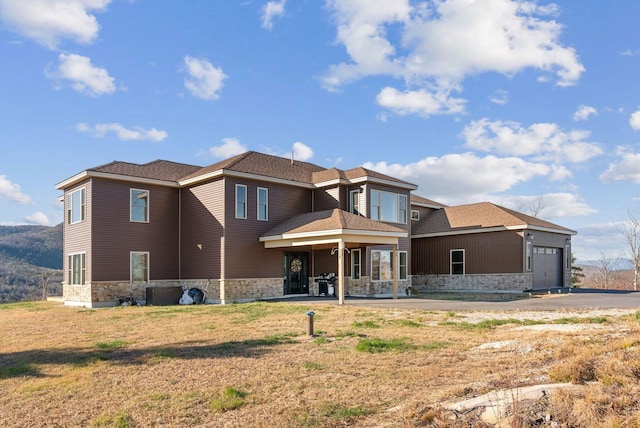 rear view of property featuring a garage